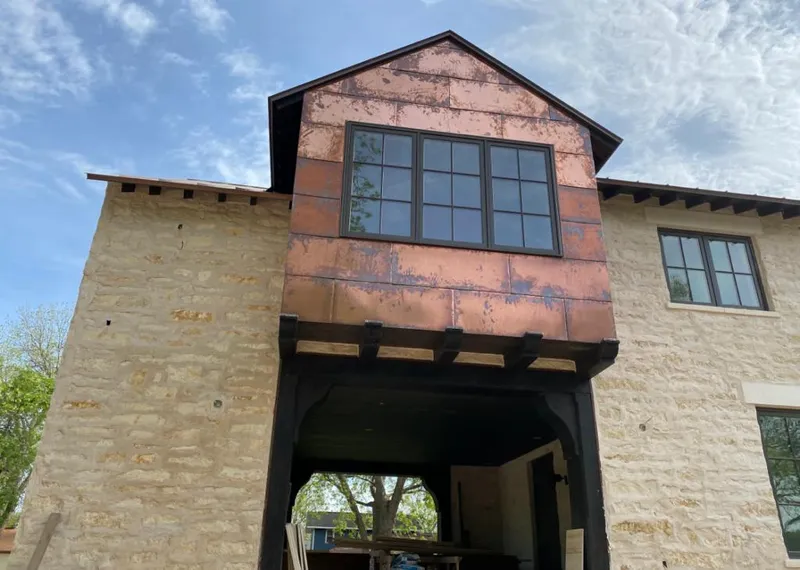 Copper metal panel facade on a stone building for Metal Roof Coating in Springtown