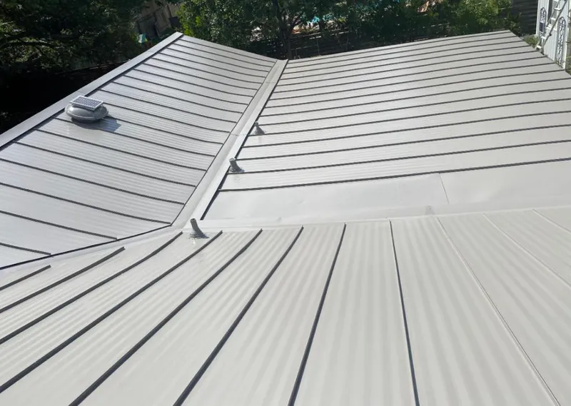 Solar attic fan installed on a metal roof for Roof Ventilation in Springtown